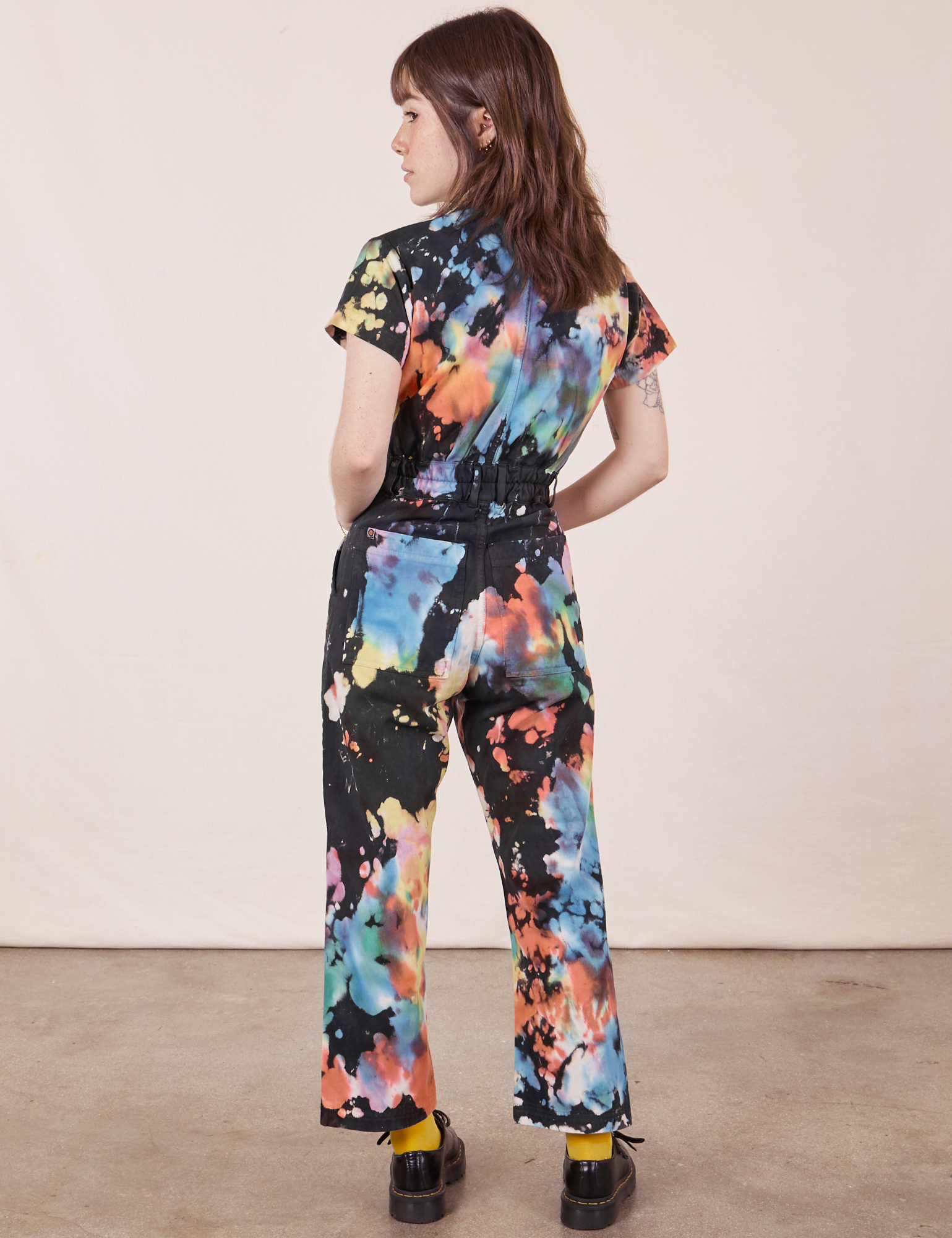 Back view of Petite Short Sleeve Jumpsuit in Rainbow Magic Waters worn by Hana