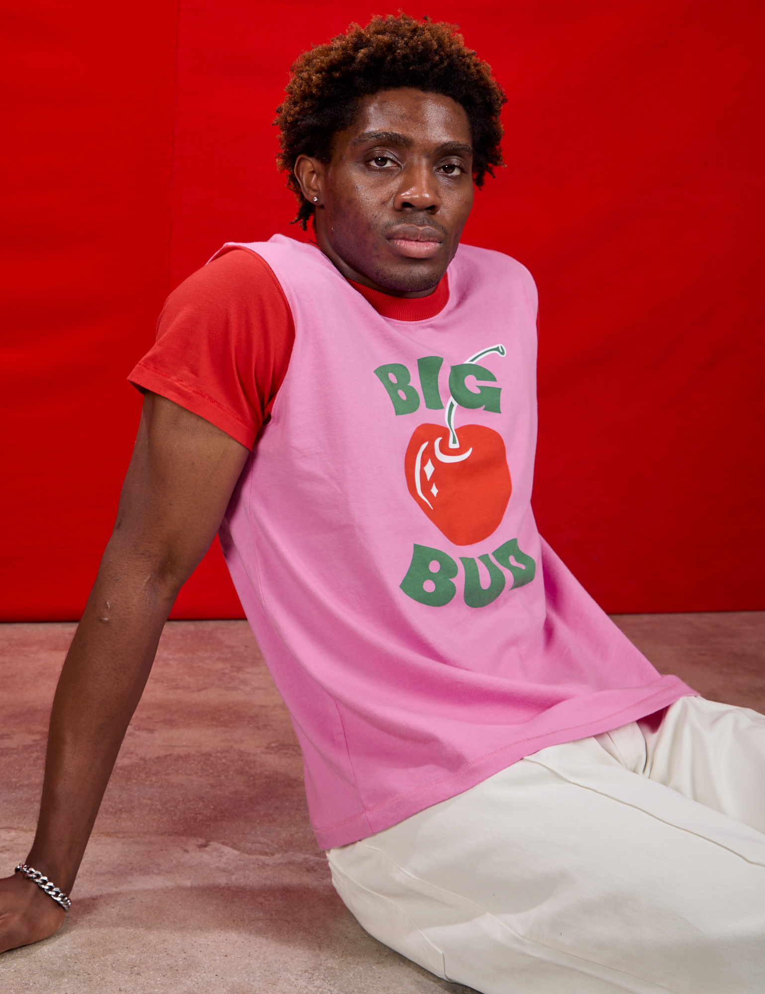 Vintage Tee in Big Red Cherry side view on Issac sitting on the ground