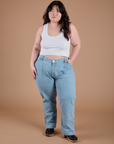 Ashley is 5’7” and wearing 1XL Carpenter Jeans in Light Wash paired with a Cropped Tank in Vintage Tee White