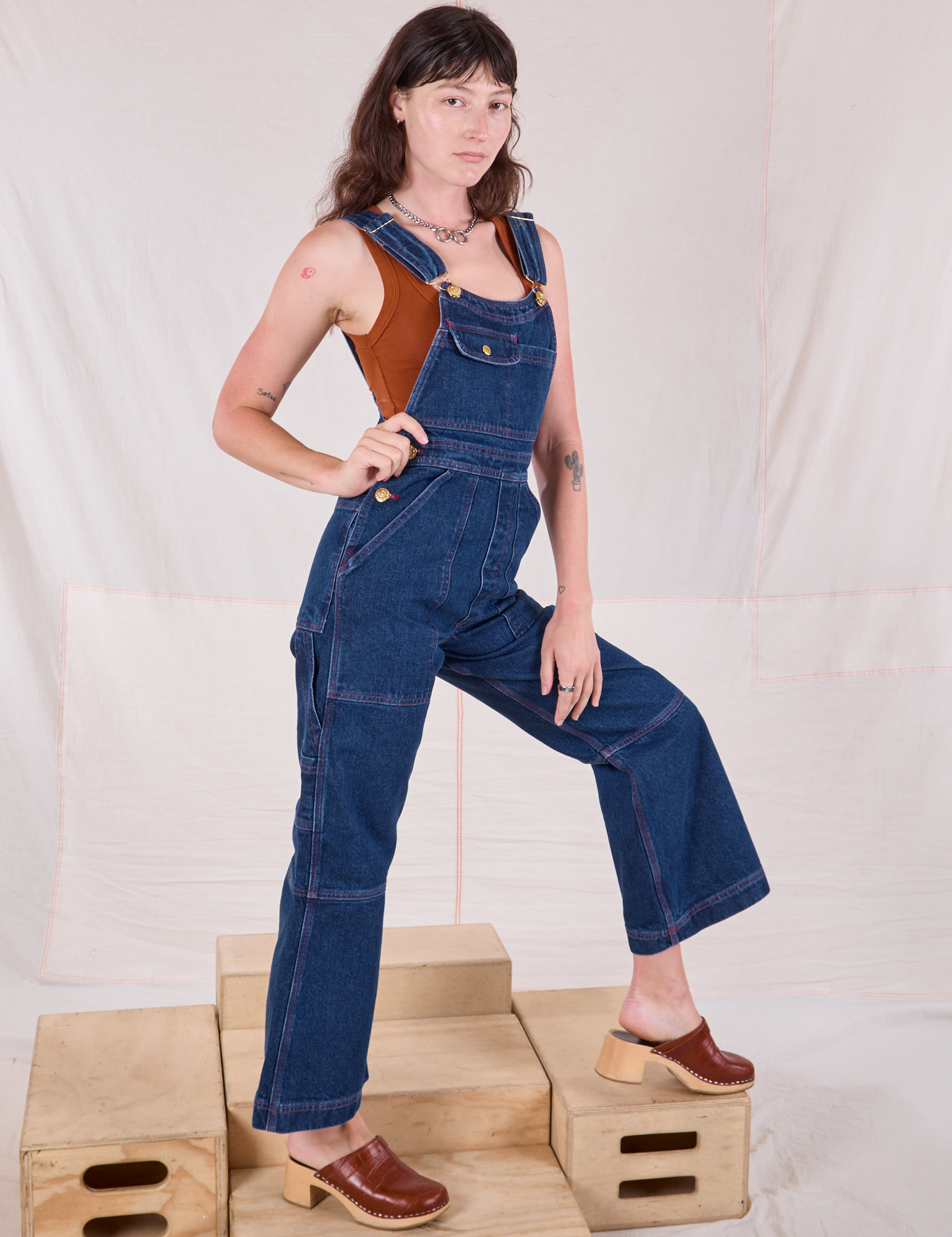 Carpenter Overalls in Dark Wash side view on Alex