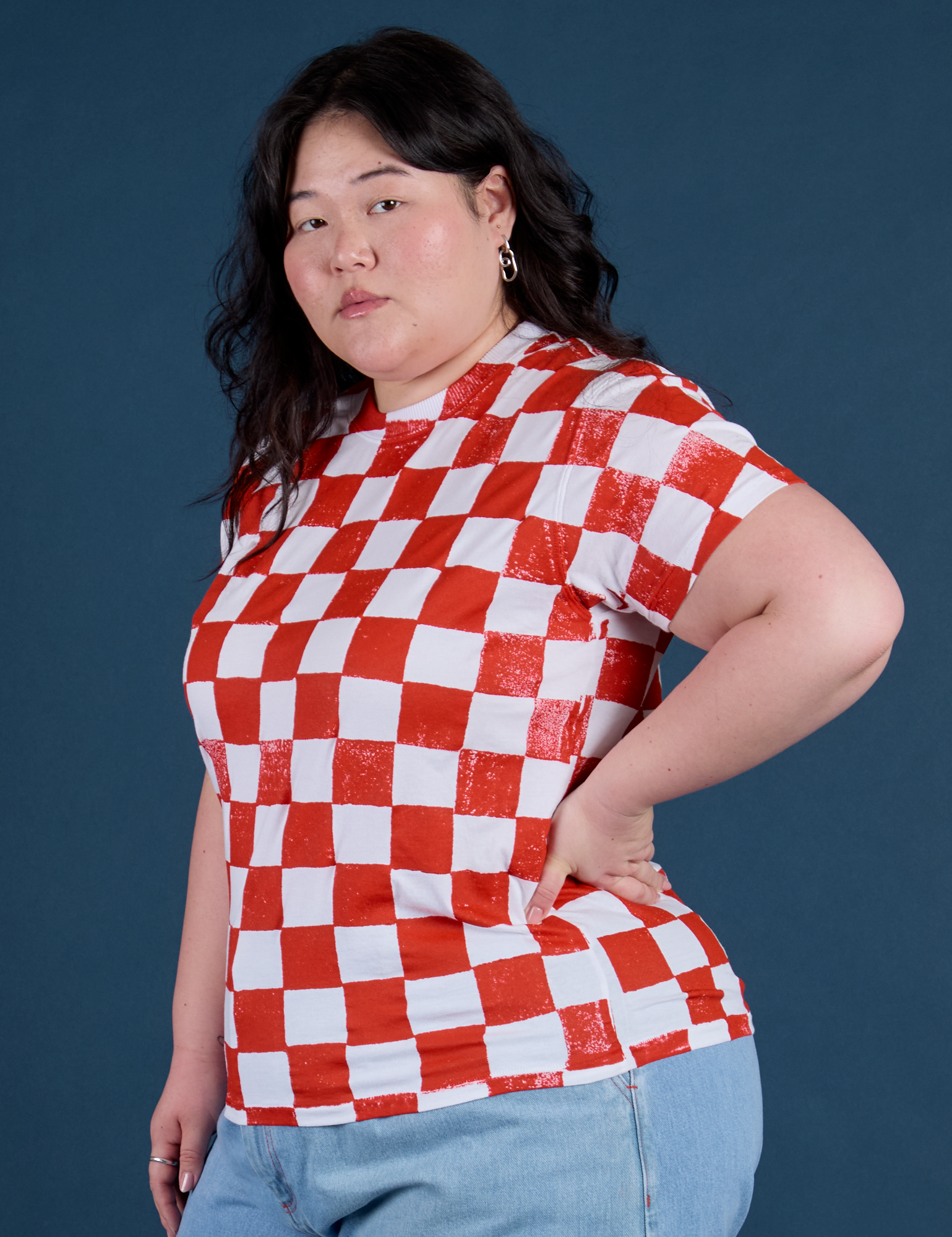 Angled front view of Checker Organic Tee in Red on Ashley