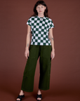 Alex is wearing Checker Organic Tee in Swamp Green and evergreen Drop Pocket Cargo Pants