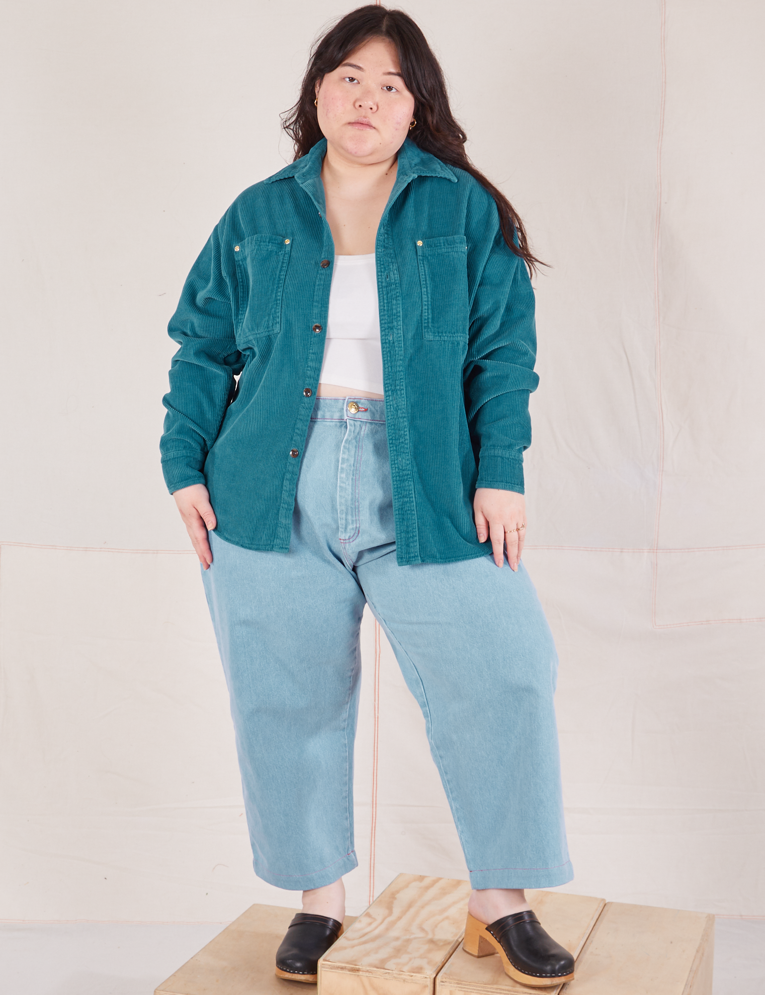 Ashley is wearing Corduroy Overshirt in Marine Blue with a vintage off-white Cami underneath paired with light wash Trouser Jeans