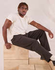 Issac is wearing Easy Pants in Espresso Brown and Organic Vintage Tee in vintage tee off-white