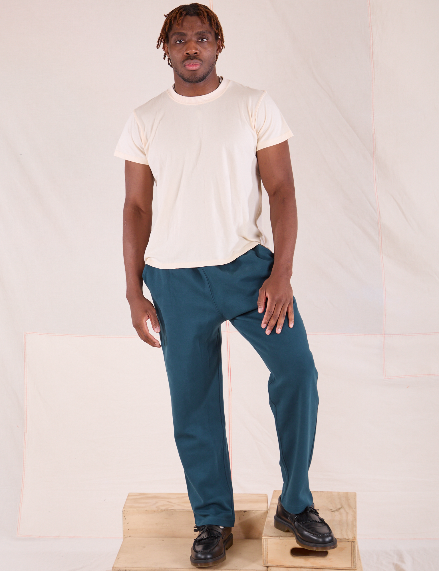 Issac is 5&#39;10&quot; and wearing M Easy Pants in Lagoon paired with Organic Vintage Tee in vintage tee off-white