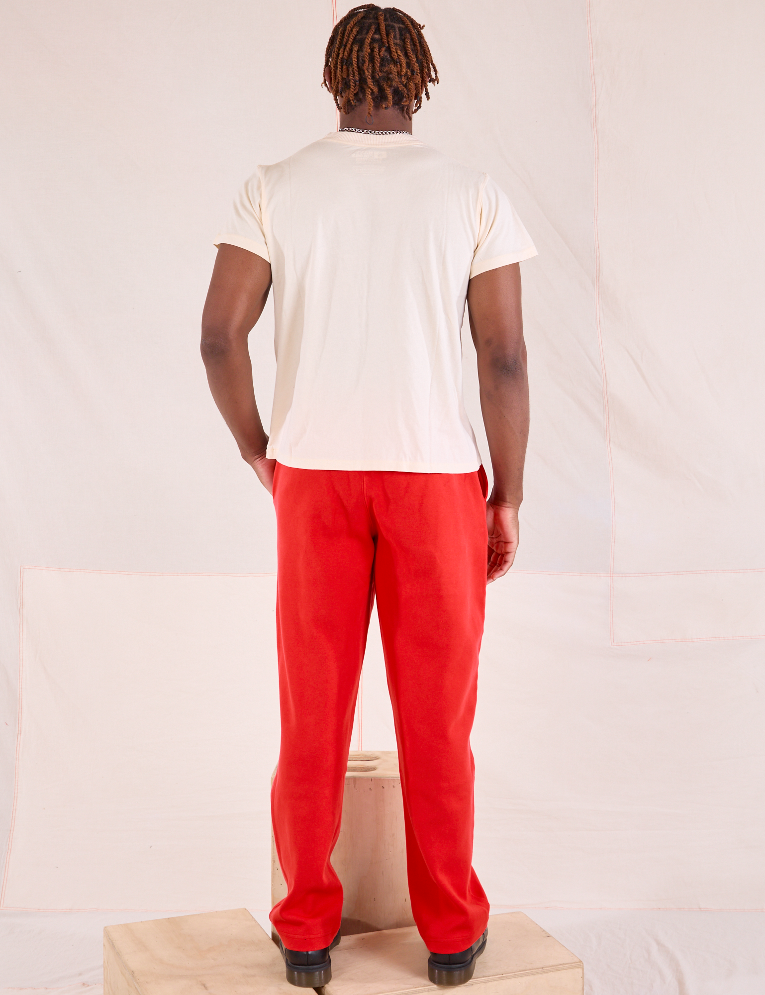 Back view of Easy Pants in Mustang Red and Organic Vintage Tee in Vintage Tee Off-White on Issac