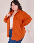 Angled front view of Flannel Overshirt in Burnt Orange on Ashley