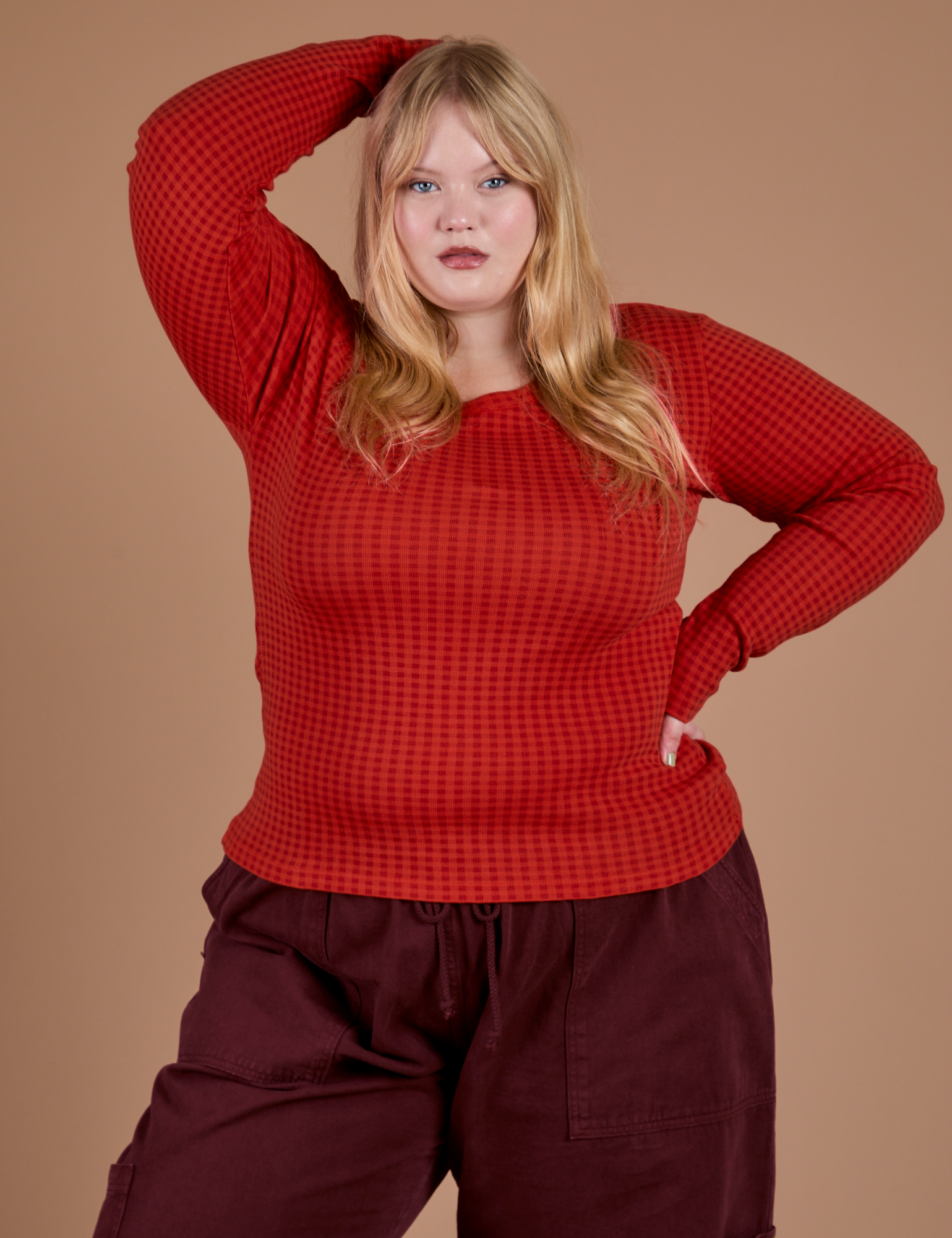 Juliet is 5’7” and wearing L Gingham Long Sleeve Baby Tee in Mustang Red