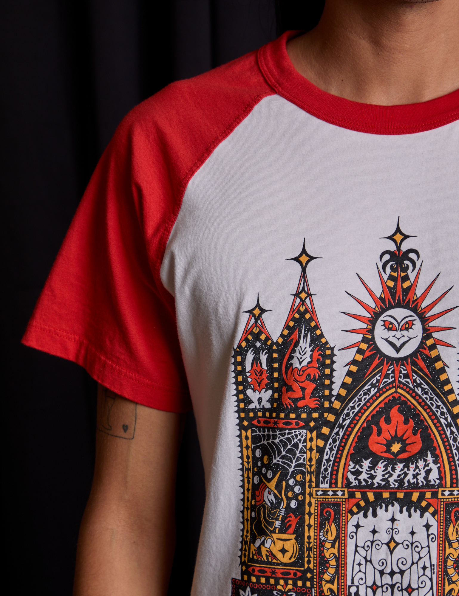 Short Sleeve Raglan Tee in Gates of Hell sleeve close up on Anthony