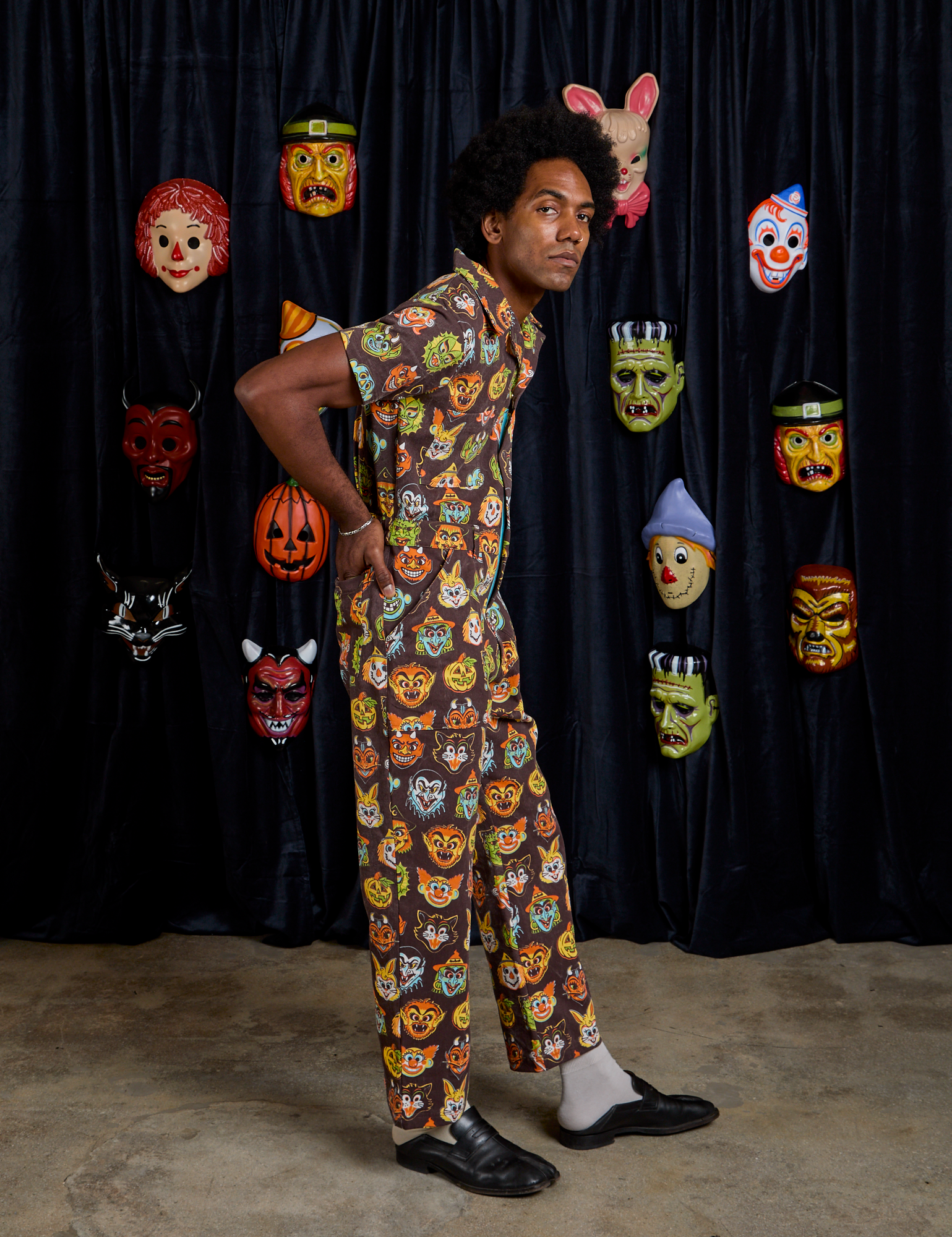 Short Sleeve Jumpsuit in Halloween Masks side view on Jerrod