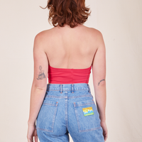 Back view of Halter Top in Hot Pink and light wash Frontier Jeans worn by Alex