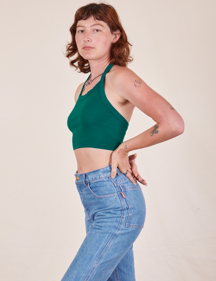 Side view of Halter Top in Hunter Green and light wash Frontier Jeans worn by Alex