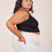 Side view of Halter Top in Basic Black and vintage off-white Western Pants worn by Alicia