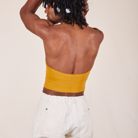 Back view of Halter Top in Mustard Yellow worn by Jerrod