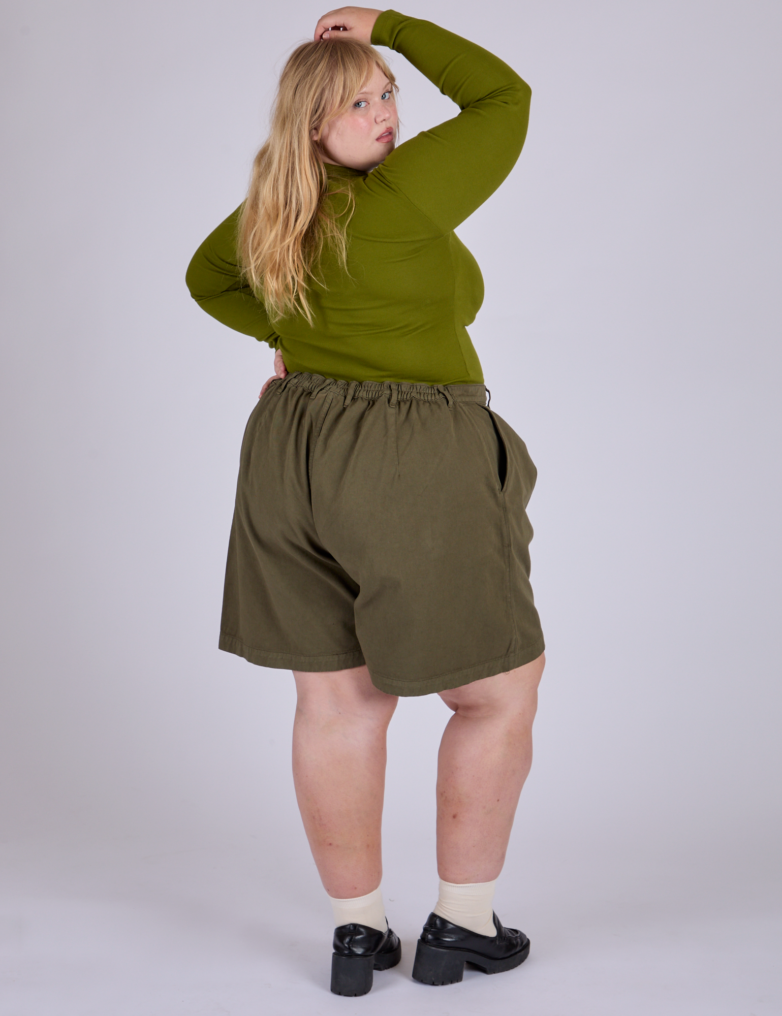 Pleated Trouser Shorts in Surplus Green back view on Juliet