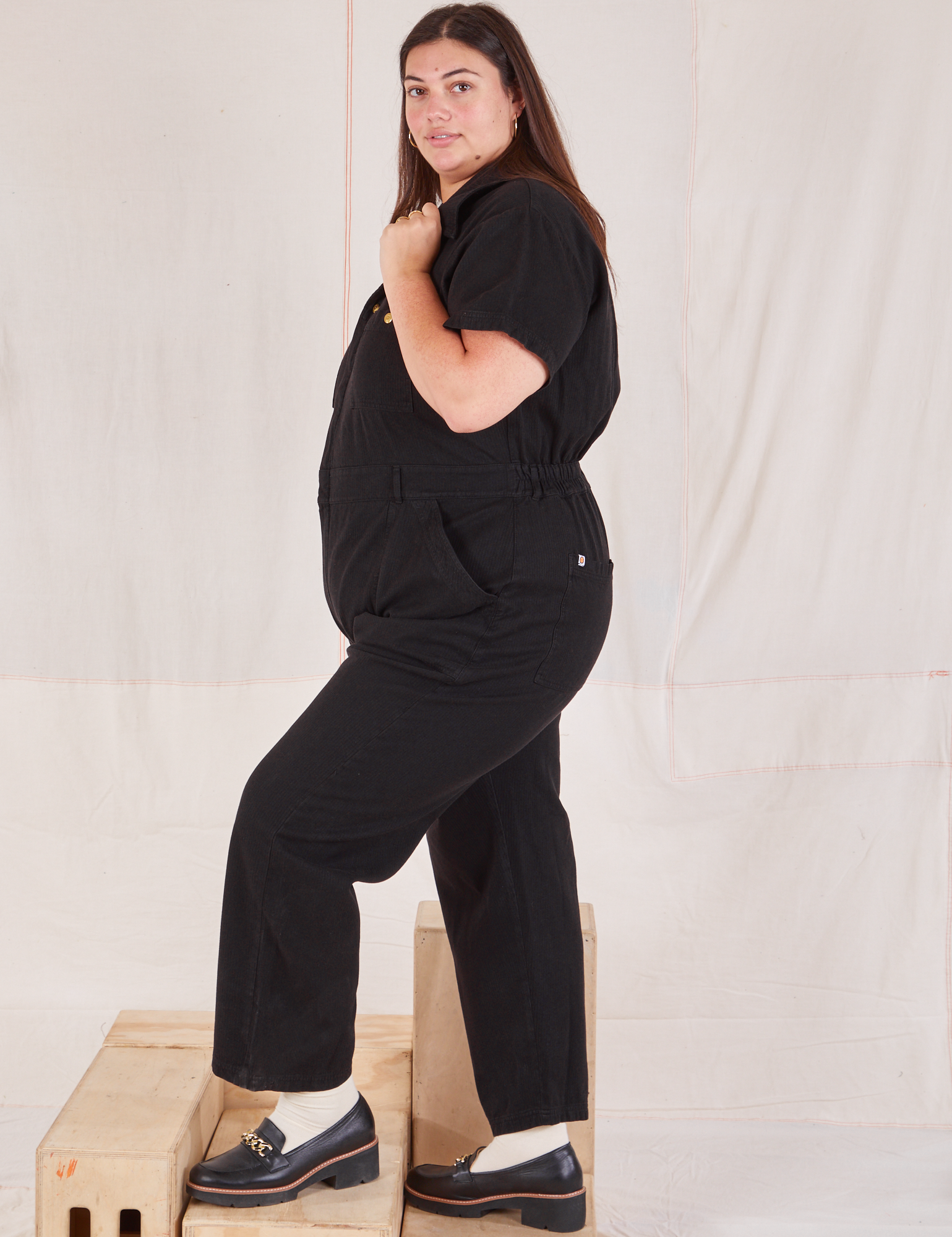 Heritage Short Sleeve Jumpsuit in Basic Black side view on Katie