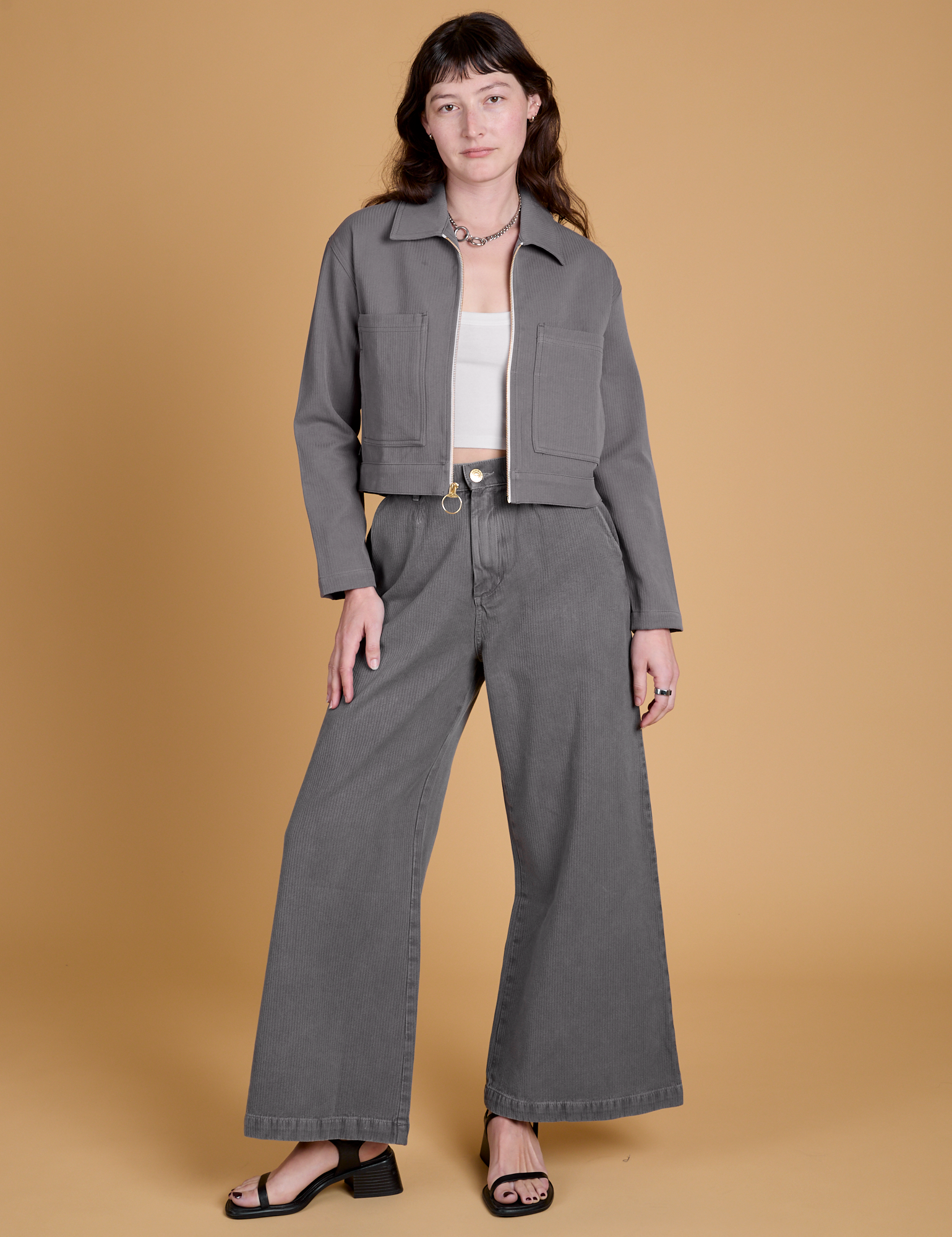 Alex is wearing Heritage Mechanic Jacket in Washed Grey and matching Wide Leg Trousers
