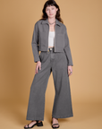 Alex is wearing Heritage Mechanic Jacket in Washed Grey and matching Wide Leg Trousers