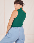 Angled back view of Sleeveless Essential Turtleneck in Hunter Green worn by Tiara