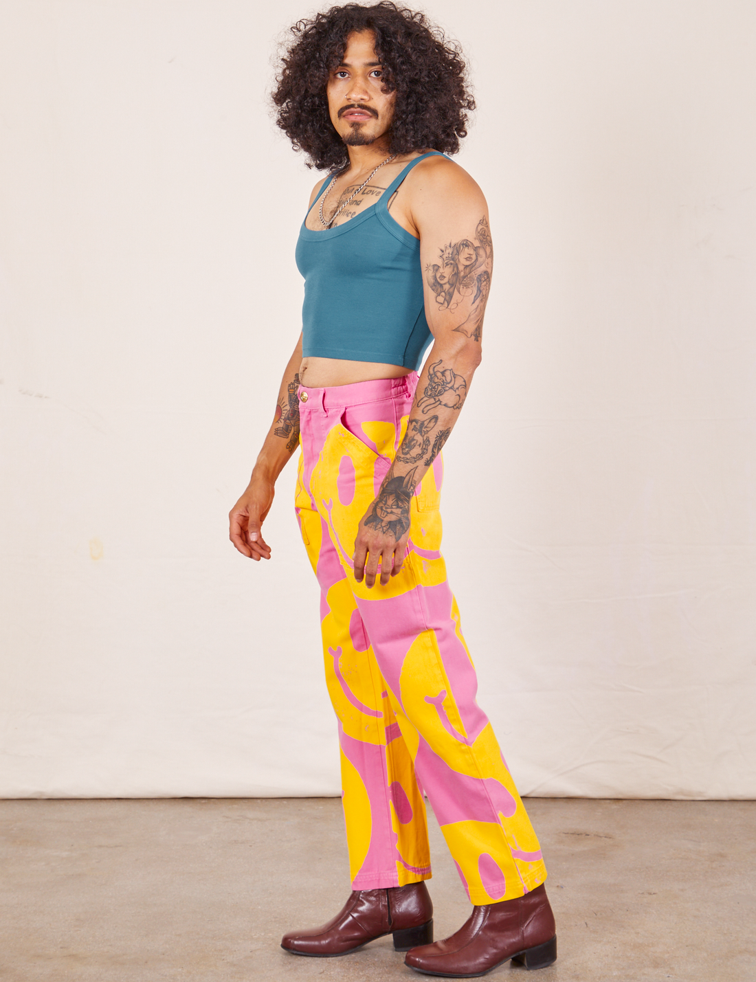 Side view of Icon Work Pants in Smilies and marine blue Cropped Cami worn by Jesse
