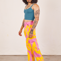 Side view of Icon Work Pants in Smilies and marine blue Cropped Cami worn by Jesse