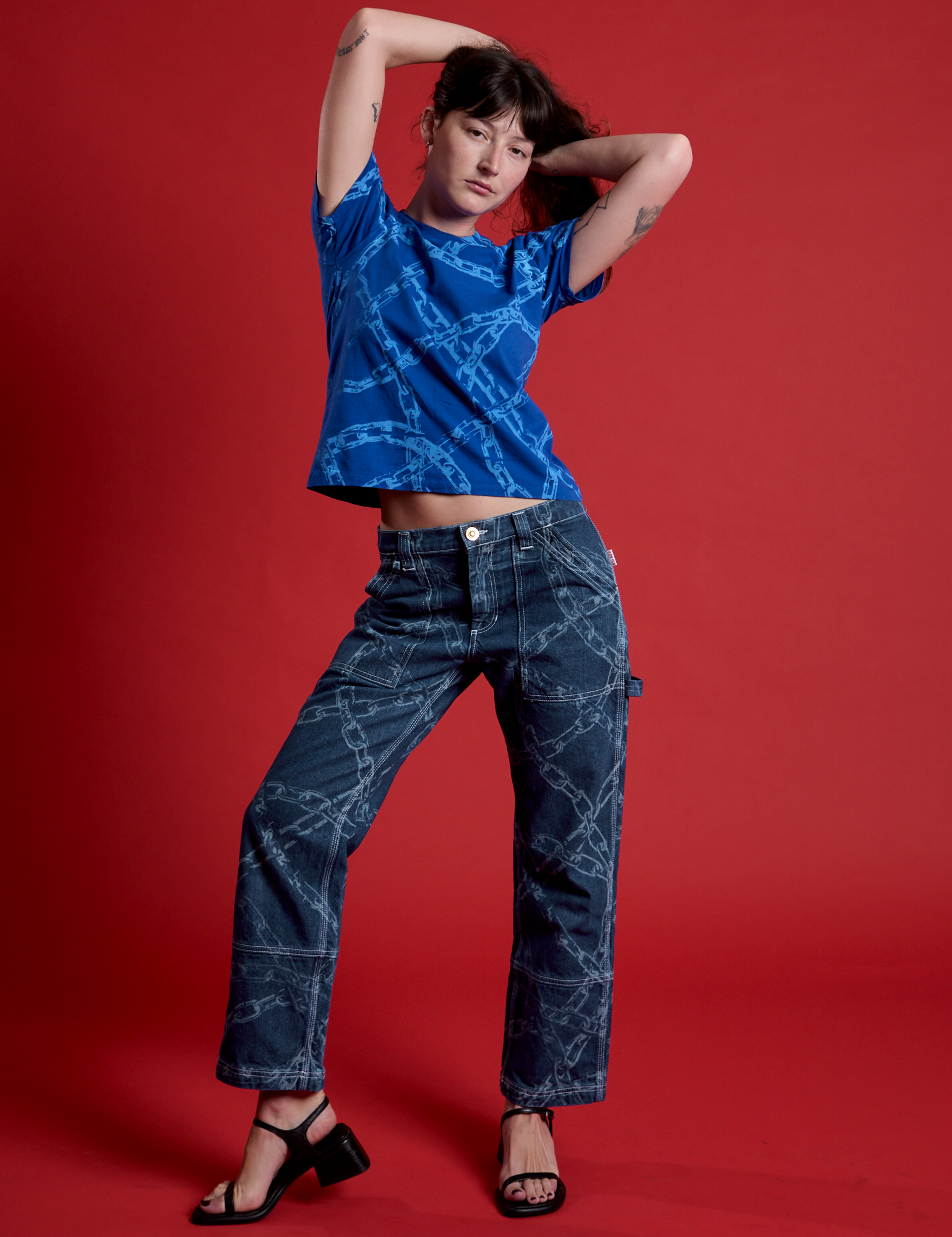 Alex is wearing Mid-Rise Carpenter Jeans in Chain Link and royal blue Chain Link Vintage Tee