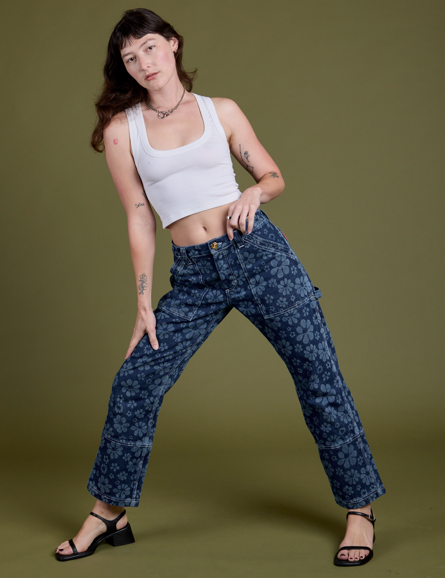 Alex has on Lazy Daisy Mid-Rise Carpenter Jeans and vintage tee white Cropped Tank