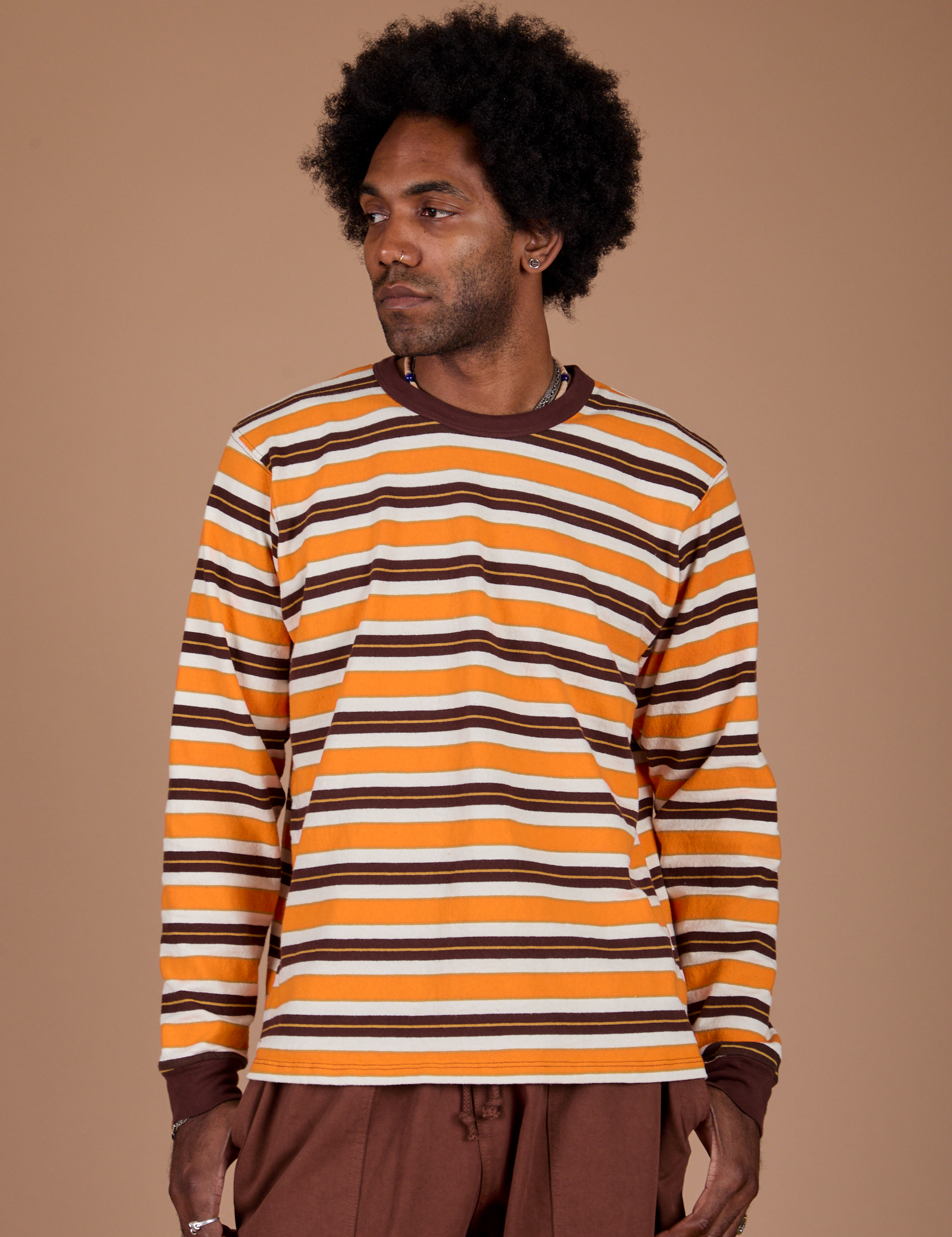 Jerrod is 6’3” and wearing M Long Sleeve Striped Burly Tee in Orange