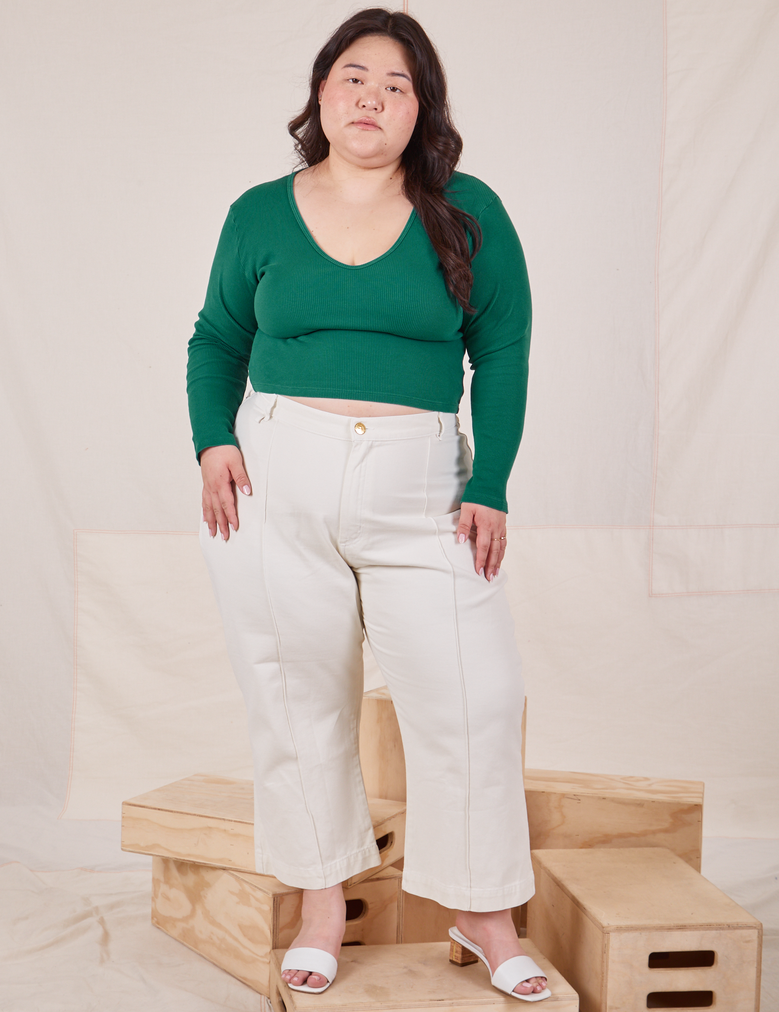 Ashley is wearing Long Sleeve V-Neck Tee in Hunter Green and vintage off-white Petite Western Pants