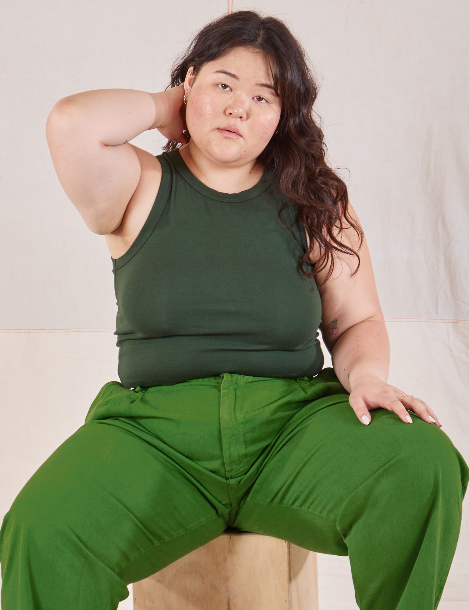 Ashley is wearing Racerback Tank in Swamp Green and lawn green Trousers