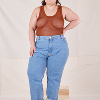 Ashley is wearing Mesh Tank Top in Burnt Terracotta and light wash Frontier Jeans