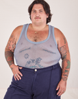 Sam is 5'10" and wearing XL Mesh Tank Top in Periwinkle paired with navy Western Pants