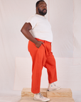 Side view of Mid-Rise Pleated Trousers in Chili Red and Organic Vintage Tee in Vintage Tee Off-White on Elijah