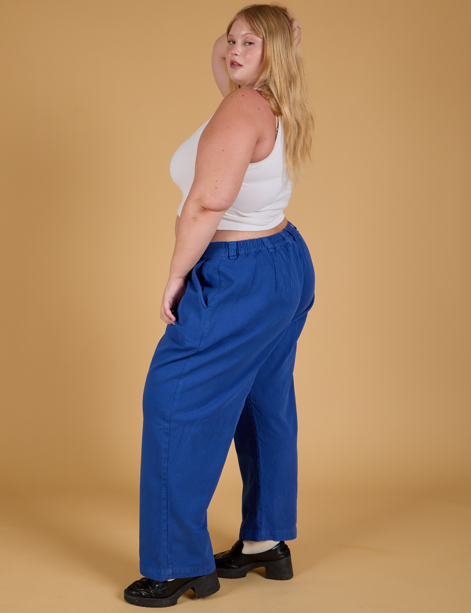 Side view of Baggy Mid-Rise Trousers in Royal Blue and vintage tee white Cropped Tank on Juliet