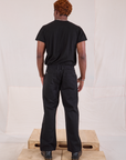 Back view of Mid-Rise Work Pants in Basic Black and black Organic Vintage Tee on Issac