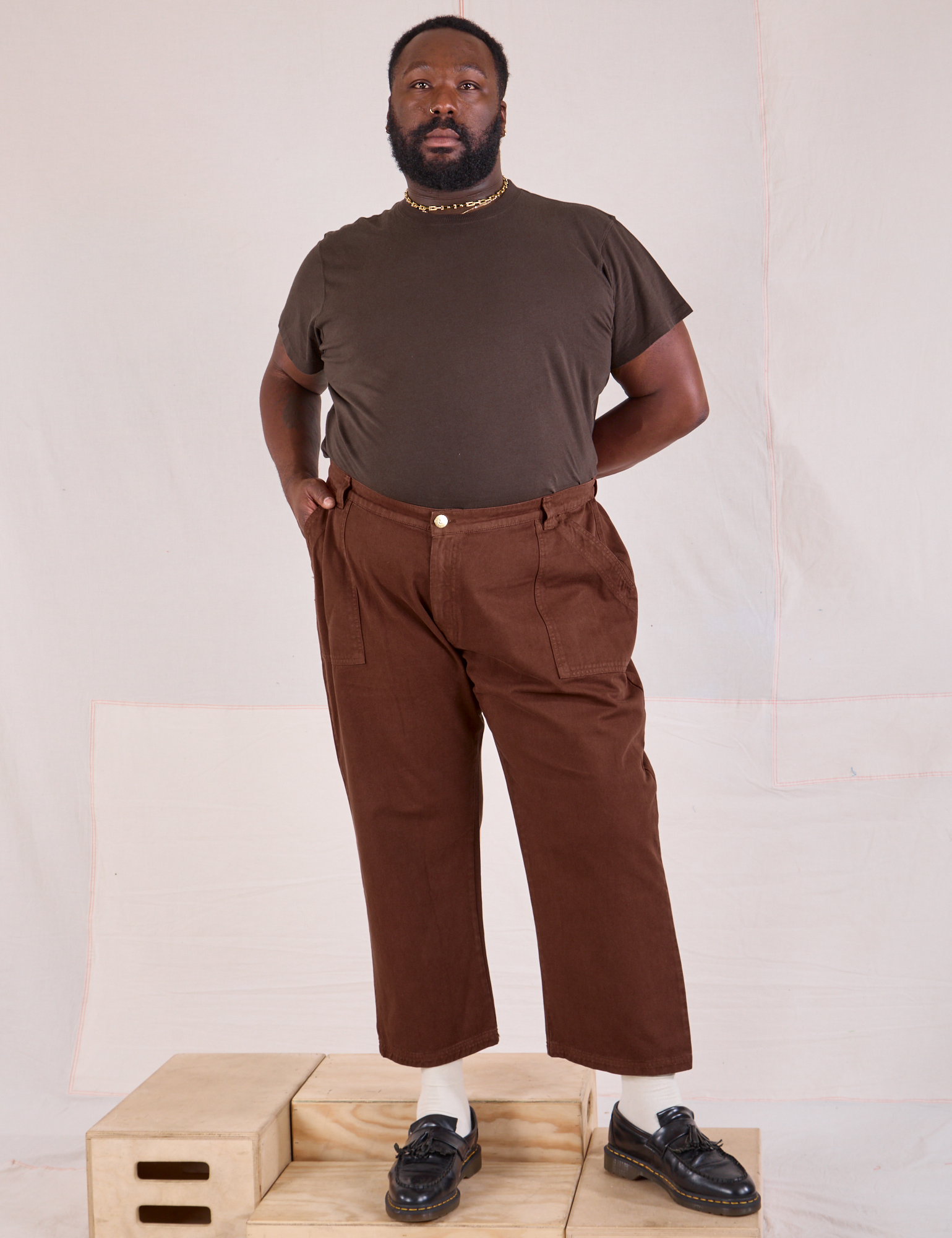 Elijah is 6&#39;3&quot; and wearing 1XL Mid-Rise Work Pants in Fudgesicle Brown paired with espresso brown Organic Vintage Tee