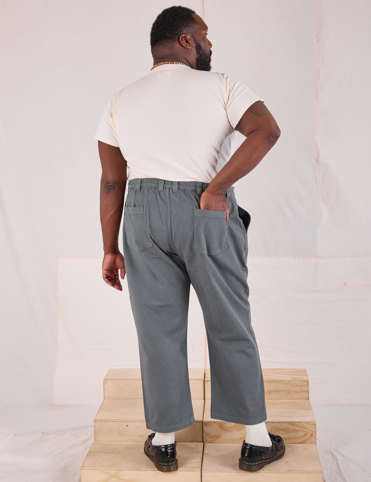 Back view of Mid-Rise Work Pants in Slate Grey and Organic Vintage Tee in vintage tee off-white on Elijah