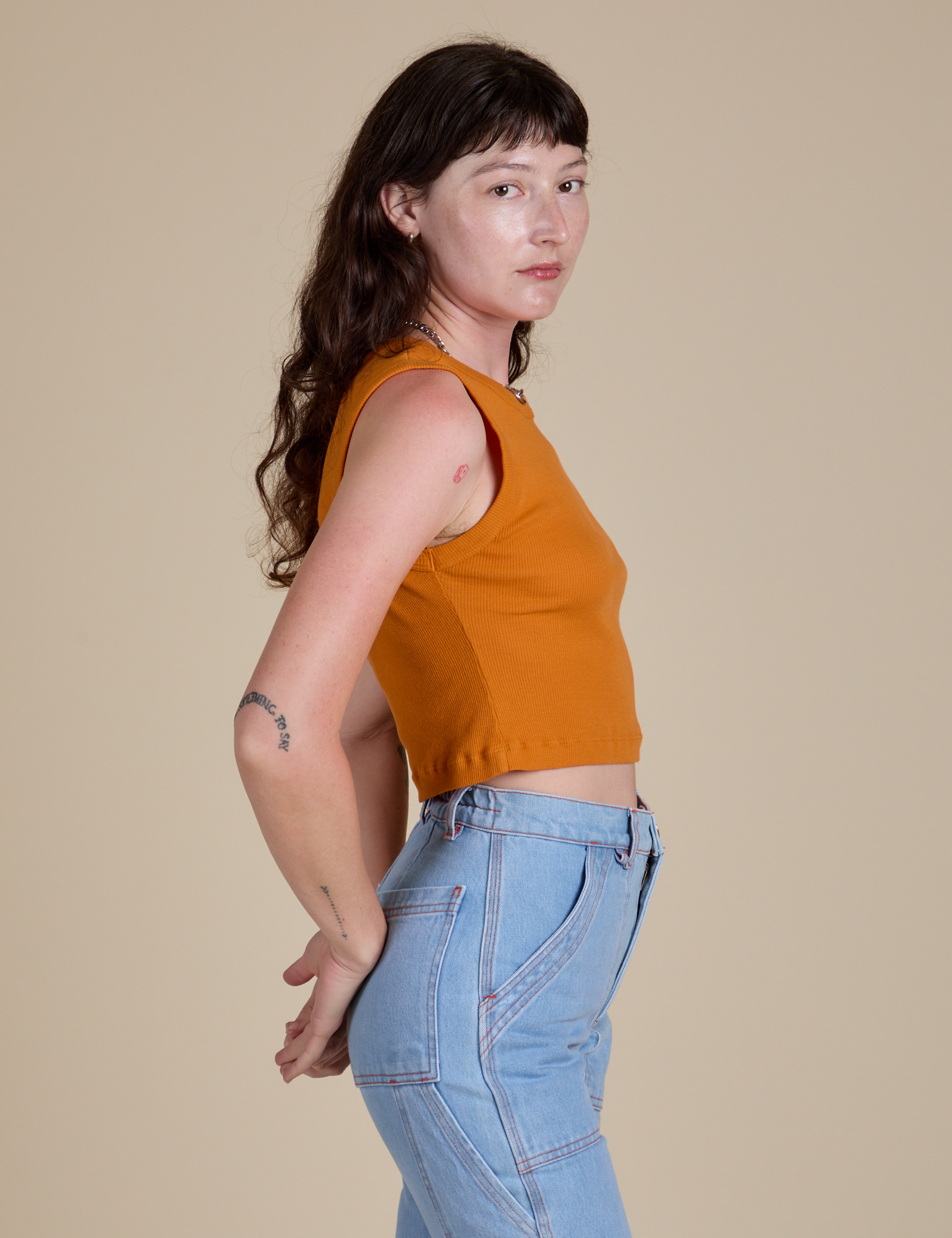 Muscle Tee in Creamsicle Orange side view on Alex
