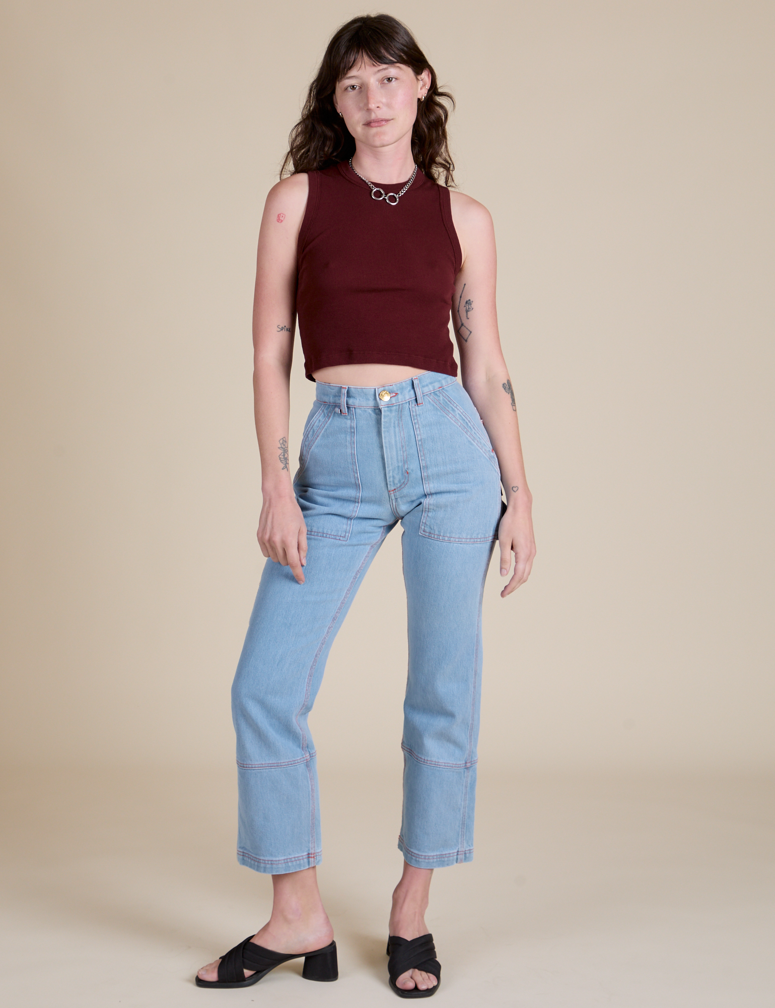 Alex is wearing  Muscle Tee in Red Wineand light wash Carpenter Jeans