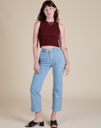 Alex is wearing  Muscle Tee in Red Wineand light wash Carpenter Jeans