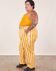 Side view of Work Pants in Lemon Stripe and mustard yellow Halter Top on Sam