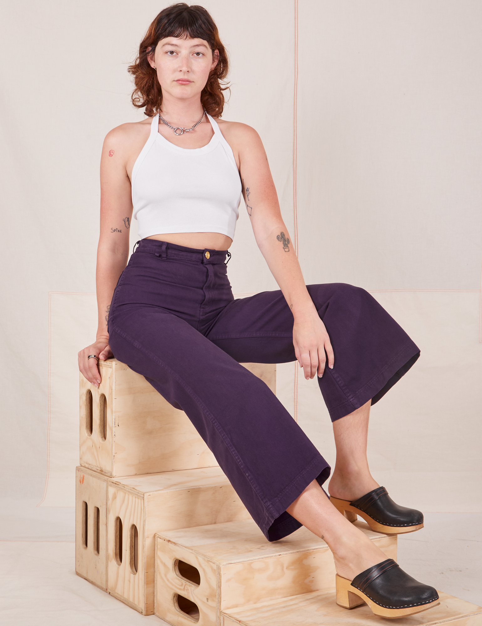 Alex is wearing Bell Bottoms in Nebula Purple and vintage off-white Halter Top