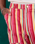 Stripe Work Pants in Cherry Candy front close up. Issac has his hand in the pocket.