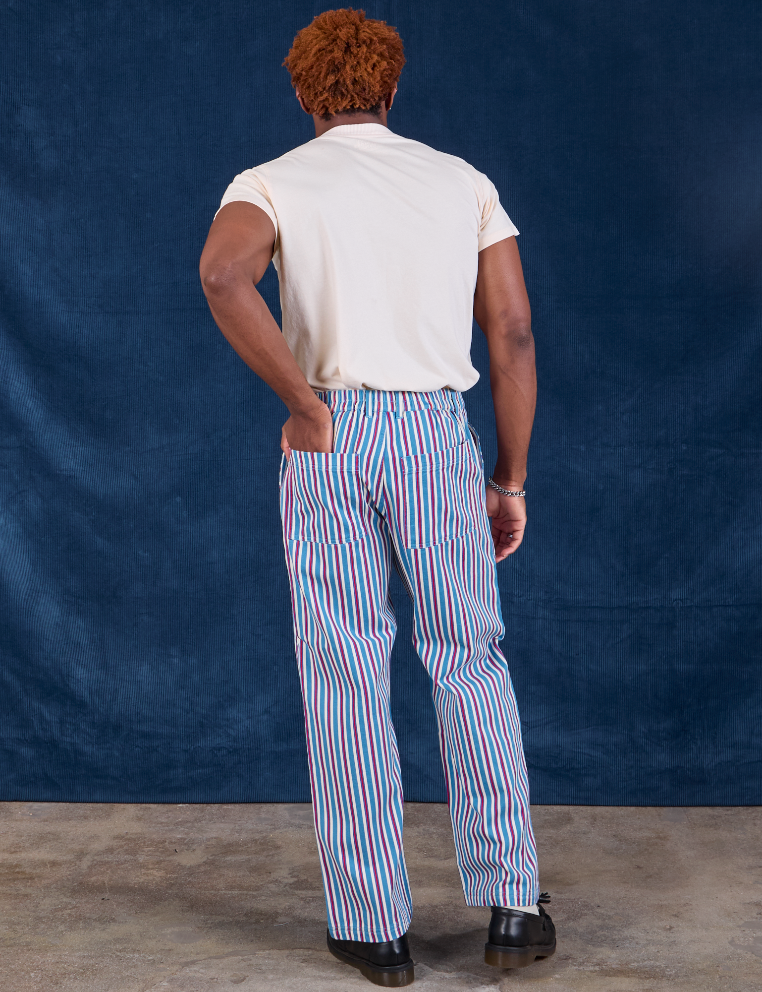 Back view of Stripe Work Pants in Blue Raspberry and Organic Vintage Tee in vintage tee off-white on Issac