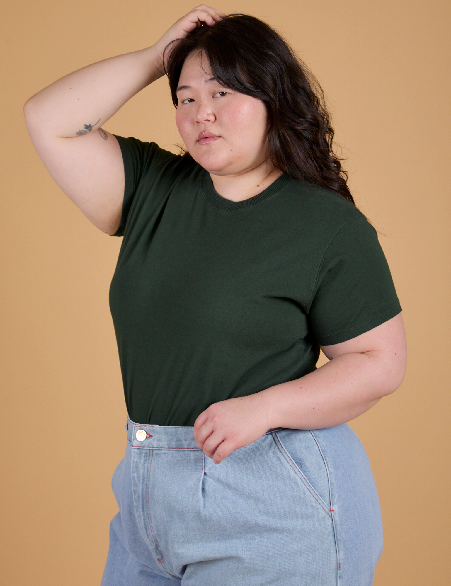 Angled front view of Organic Vintage Tee in Swamp Green on Ashley