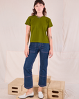 Alex is wearing Organic Vintage Tee in Summer Olive and dark wash Carpenter Jeans