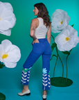 Back view of Paintstamped Work Pants in Daisy and Cropped Tank in Vintage Tee White on Alex