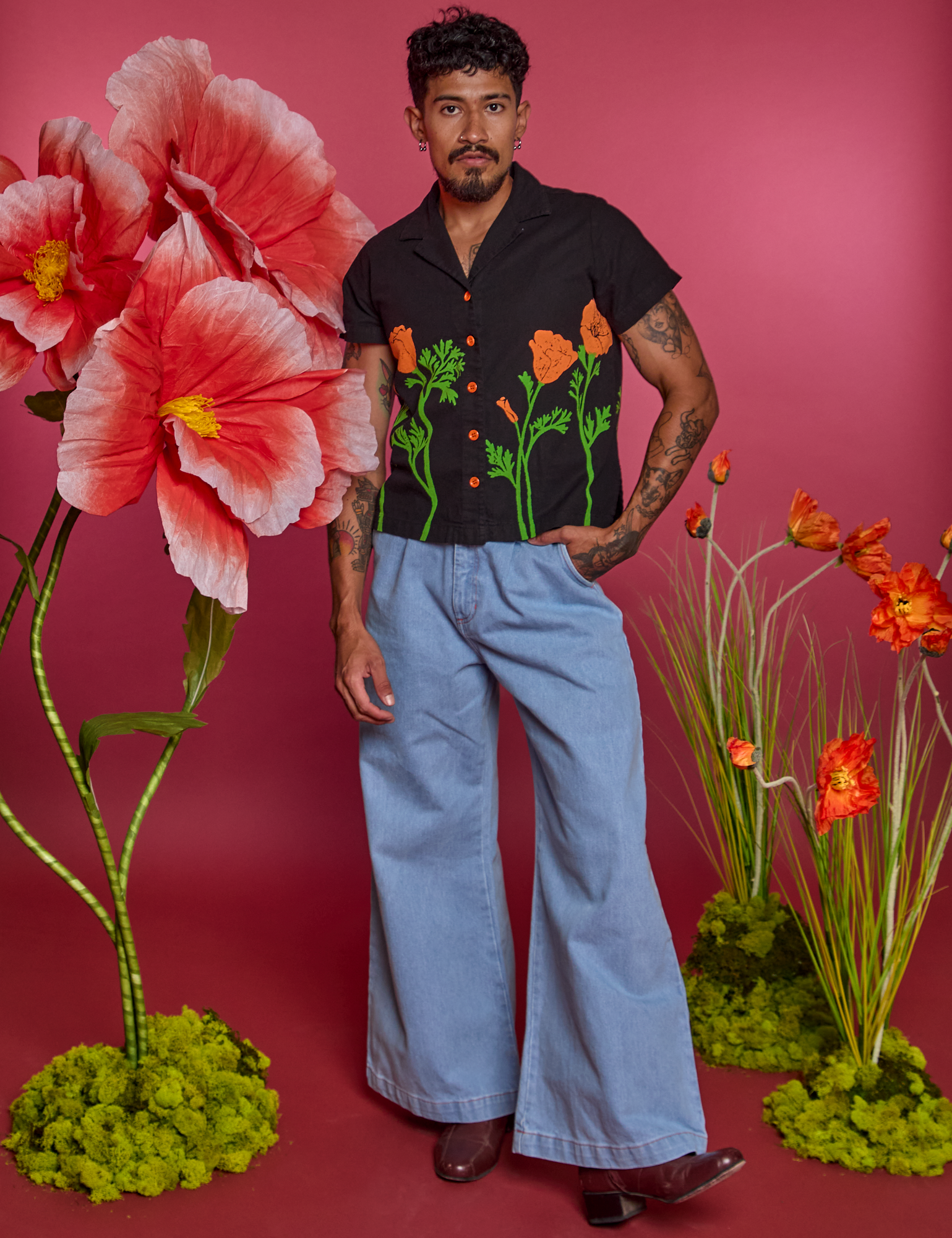 Jesse is wearing Paintstamped Pantry Button-Up in Poppy and light wash Indigo Denim Wide Leg Trousers