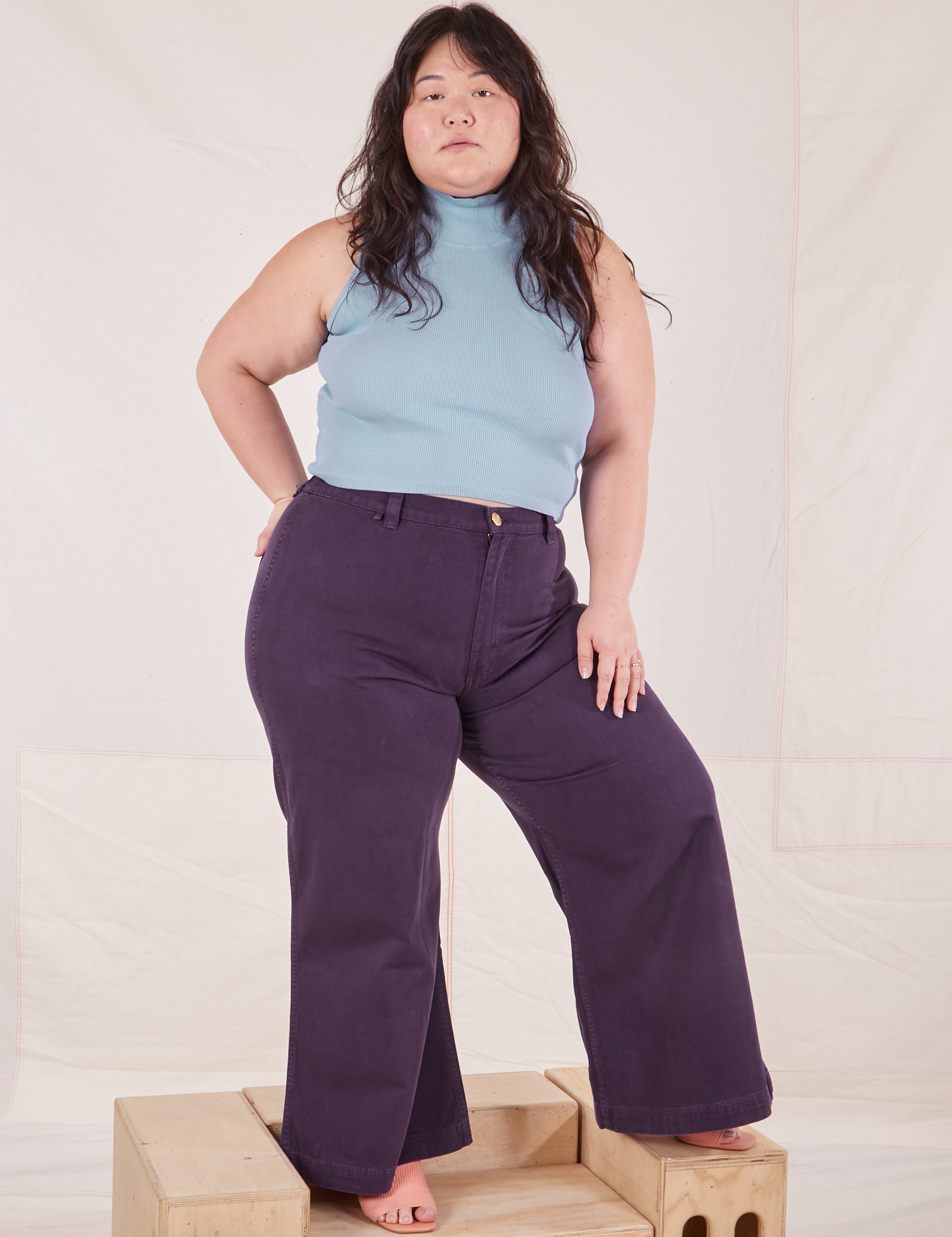 Ashley is wearing Sleeveless Essential Turtleneck in Periwinkle and nebula purple Bell Bottoms