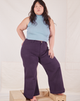 Ashley is wearing Sleeveless Essential Turtleneck in Periwinkle and nebula purple Bell Bottoms